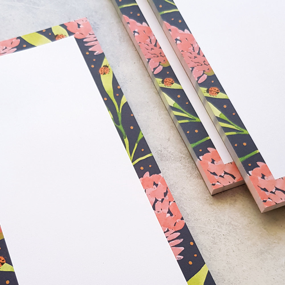 close up of blank pink banksia notepads