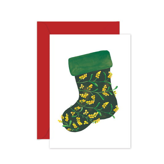 Green Christmas stocking with yellow wattle flowers on a white card with a red envelope