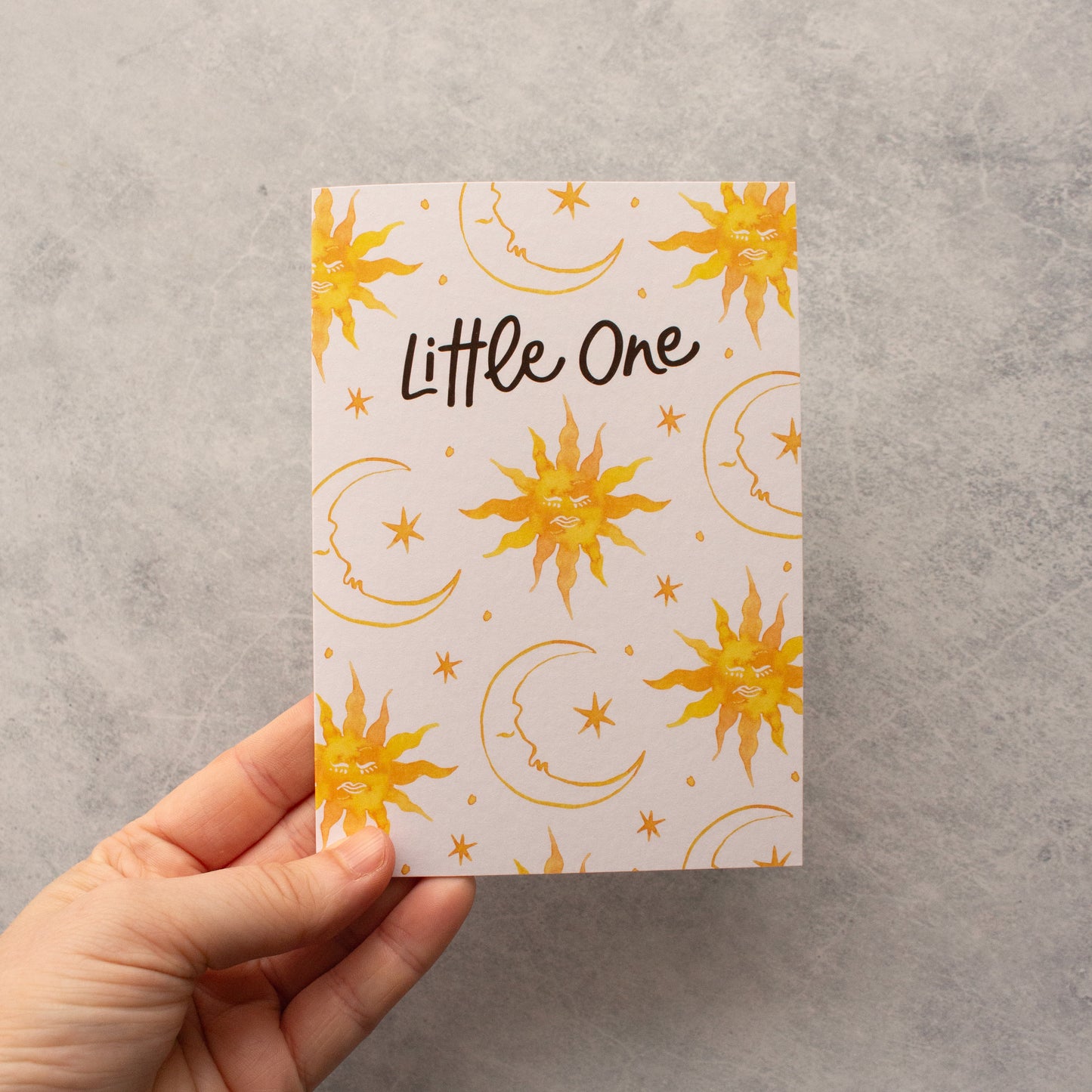 Baby greeting card with 'Little One' message and a celestial design featuring suns, moons, and stars, ideal for newborn celebrations.