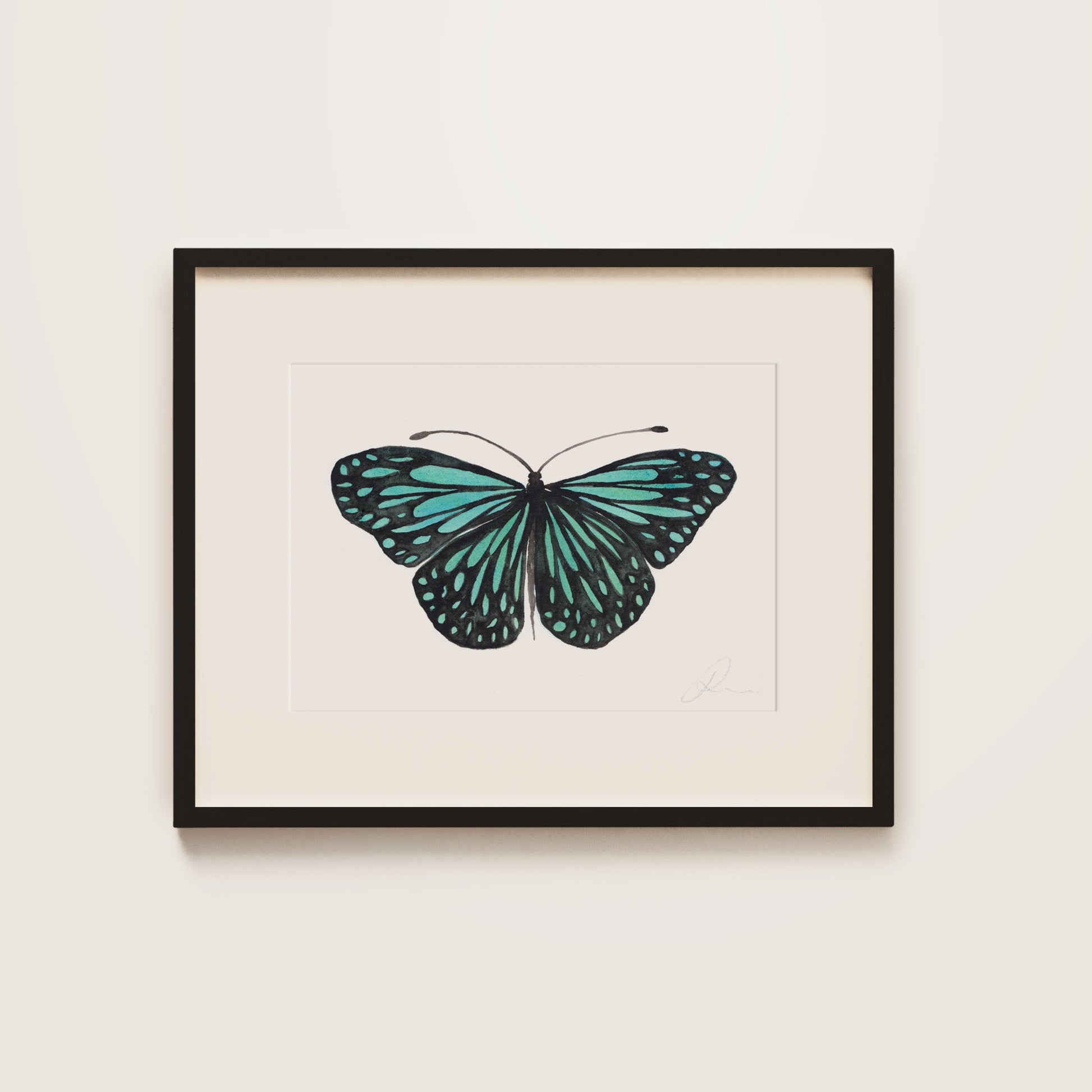 Framed artwork of a turquoise butterfly on a white background in a black frame