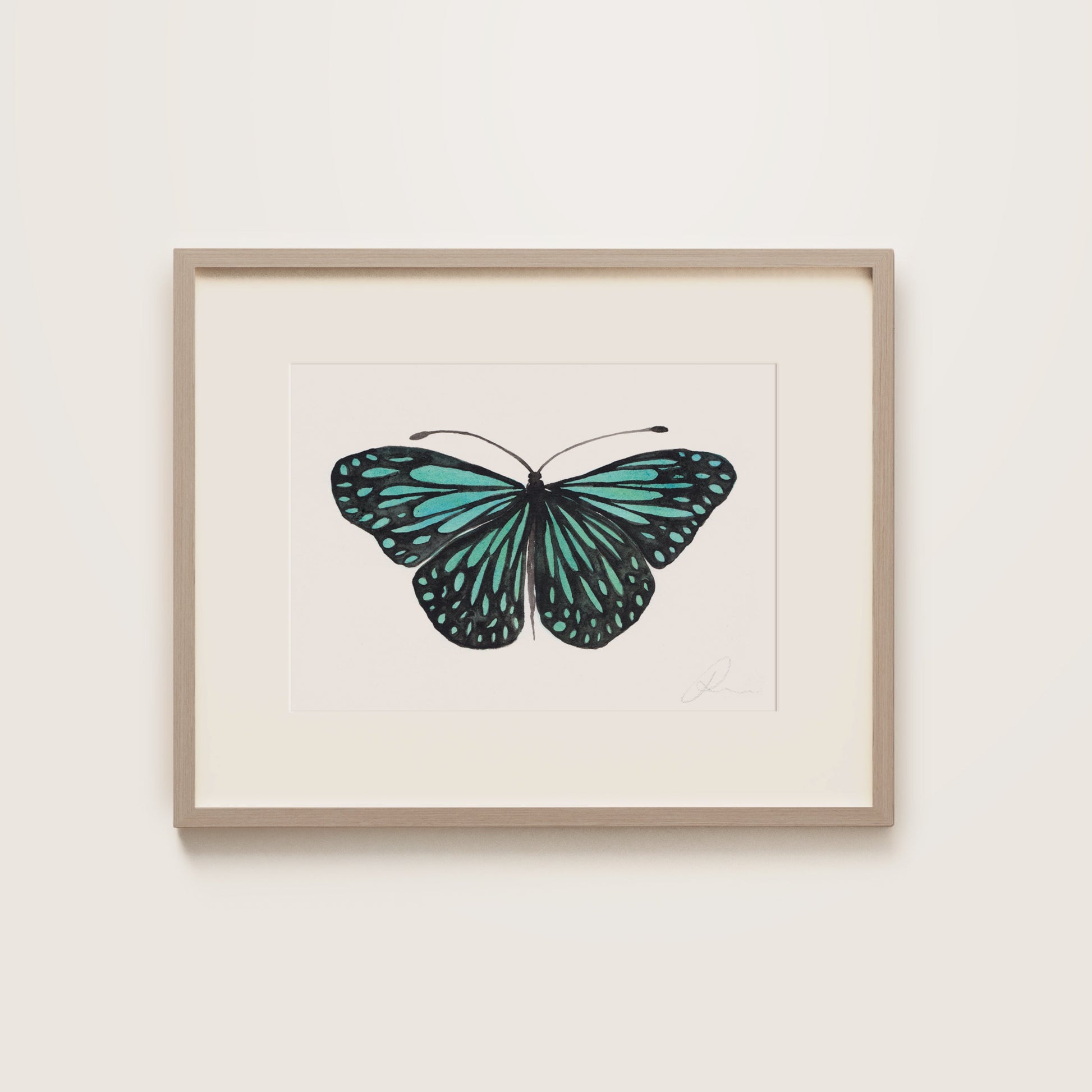 Framed artwork of a turquoise butterfly on a white background