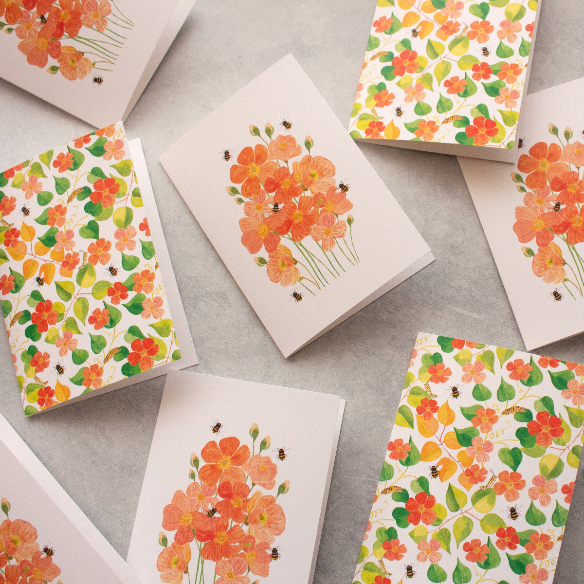 Floral patterned cards on a grey surface