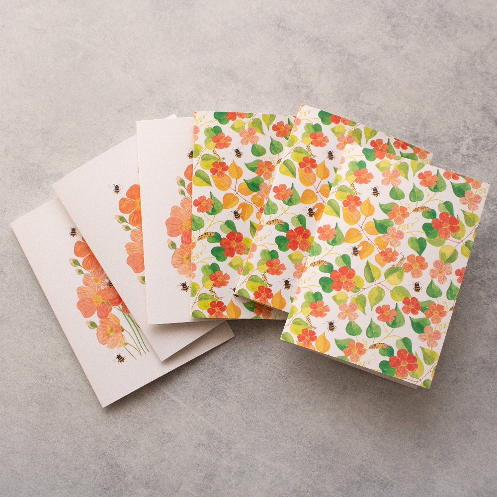 Floral patterned cards on a grey surface
