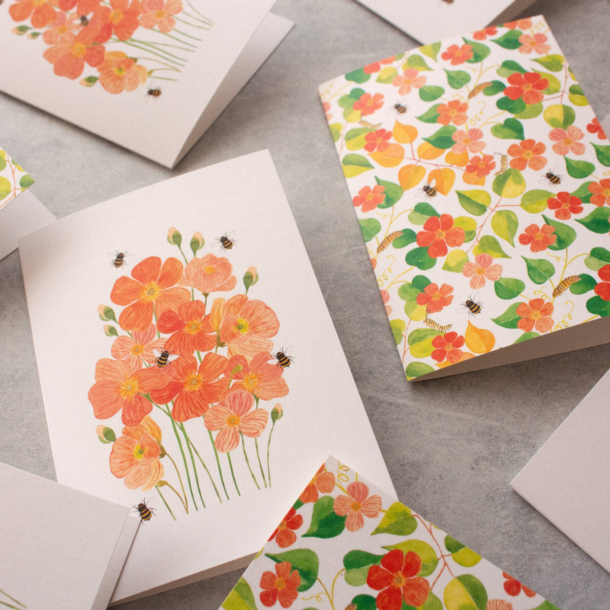Floral patterned cards on a grey surface