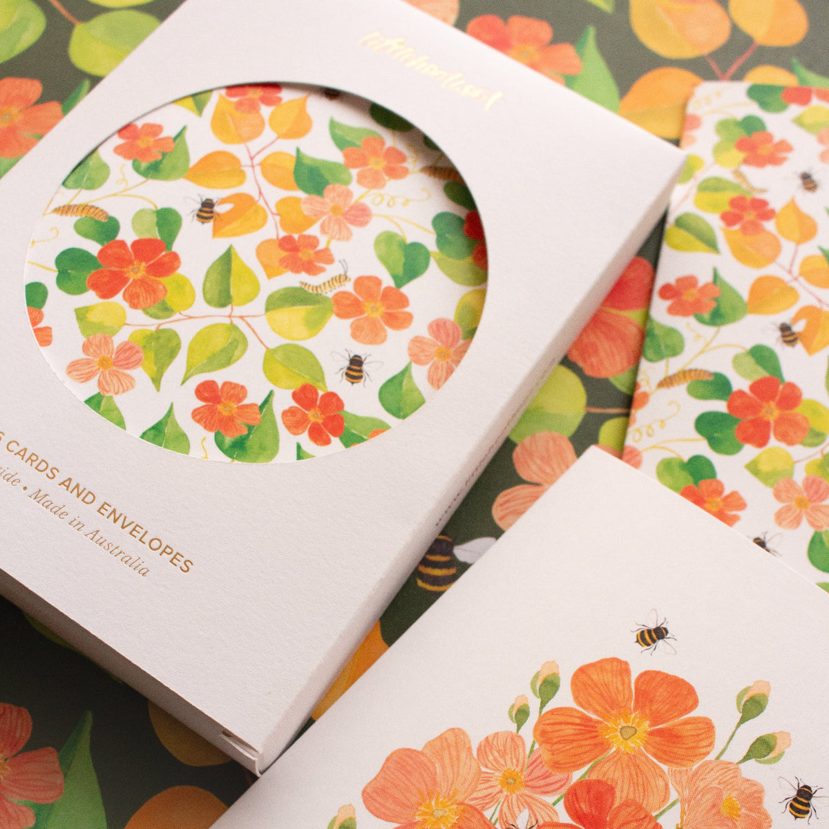 Floral cards and envelopes with colourful designs on a patterned background