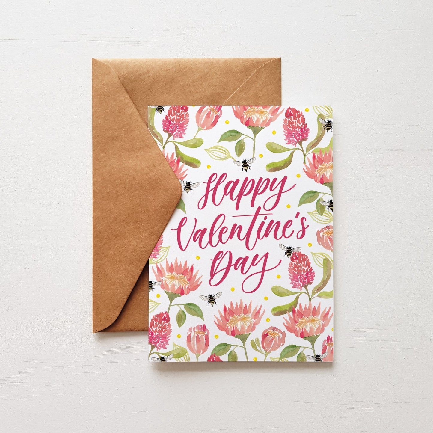 Valentine's Day card with floral design and brown envelope on white background