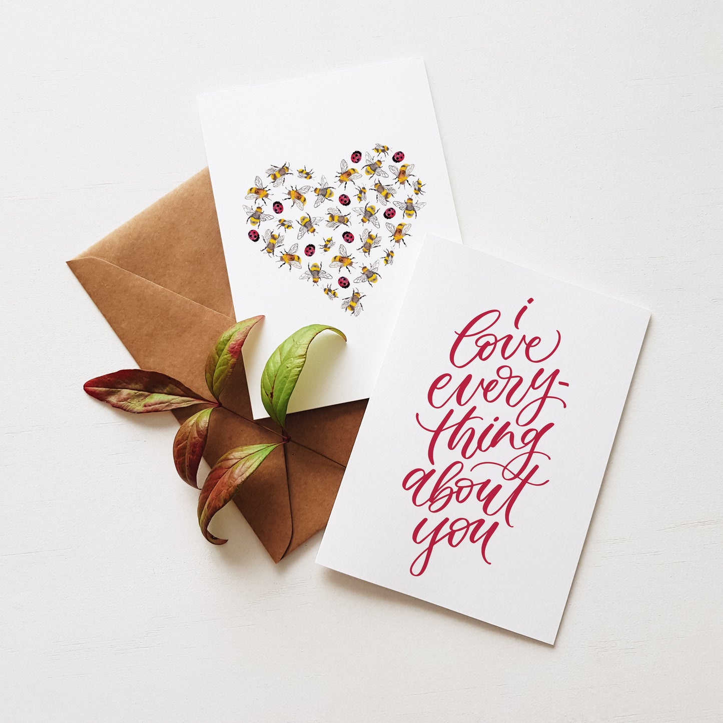 Two greeting love cards. One card shows a heart made of bugs, and the other has red text 'I Iove everything about you'