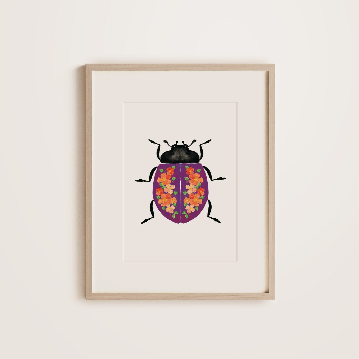 Purple lady beetle with floral pattern on shell in wooden frame