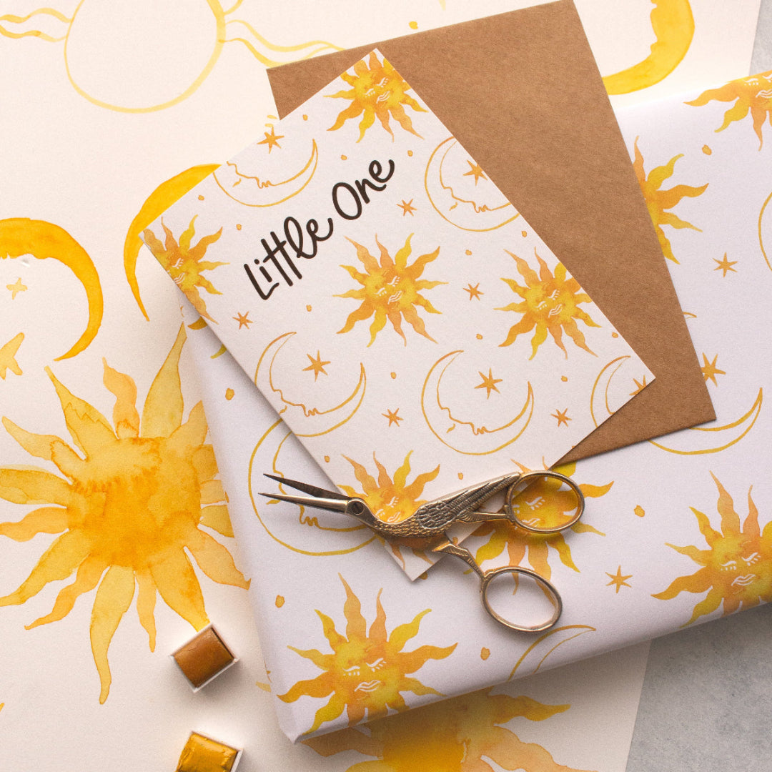 Little One baby greeting card with suns, moons, and stars, paired with matching celestial wrapping paper. A perfect set for newborn gifts and baby showers.