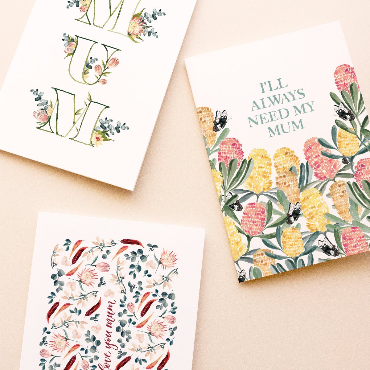 Three colourful floral mother's day greeting cards on a beige background