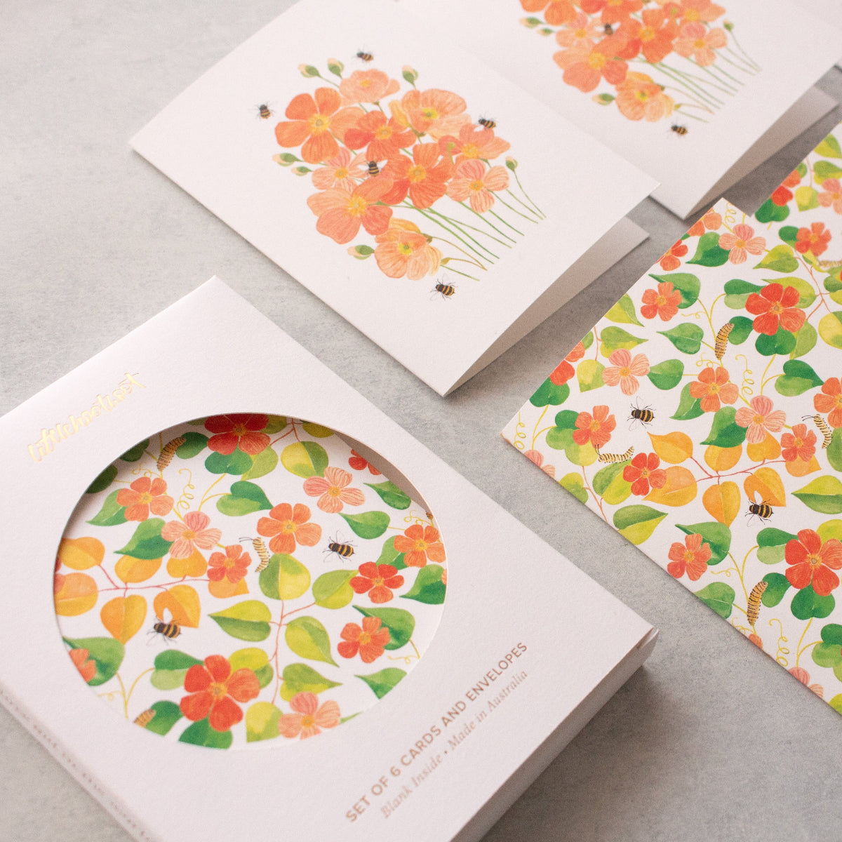 Floral-patterned cards on a grey surface