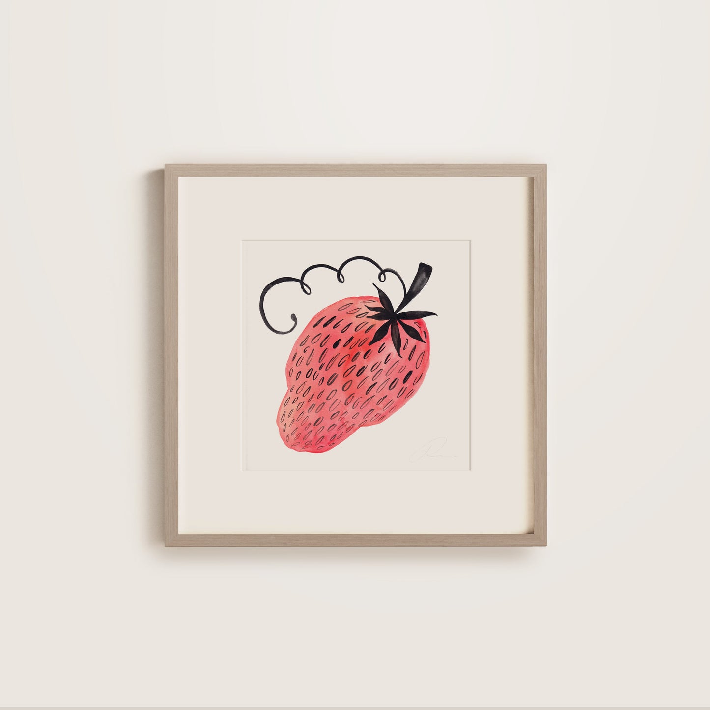 Framed artwork of a strawberry on a white wall