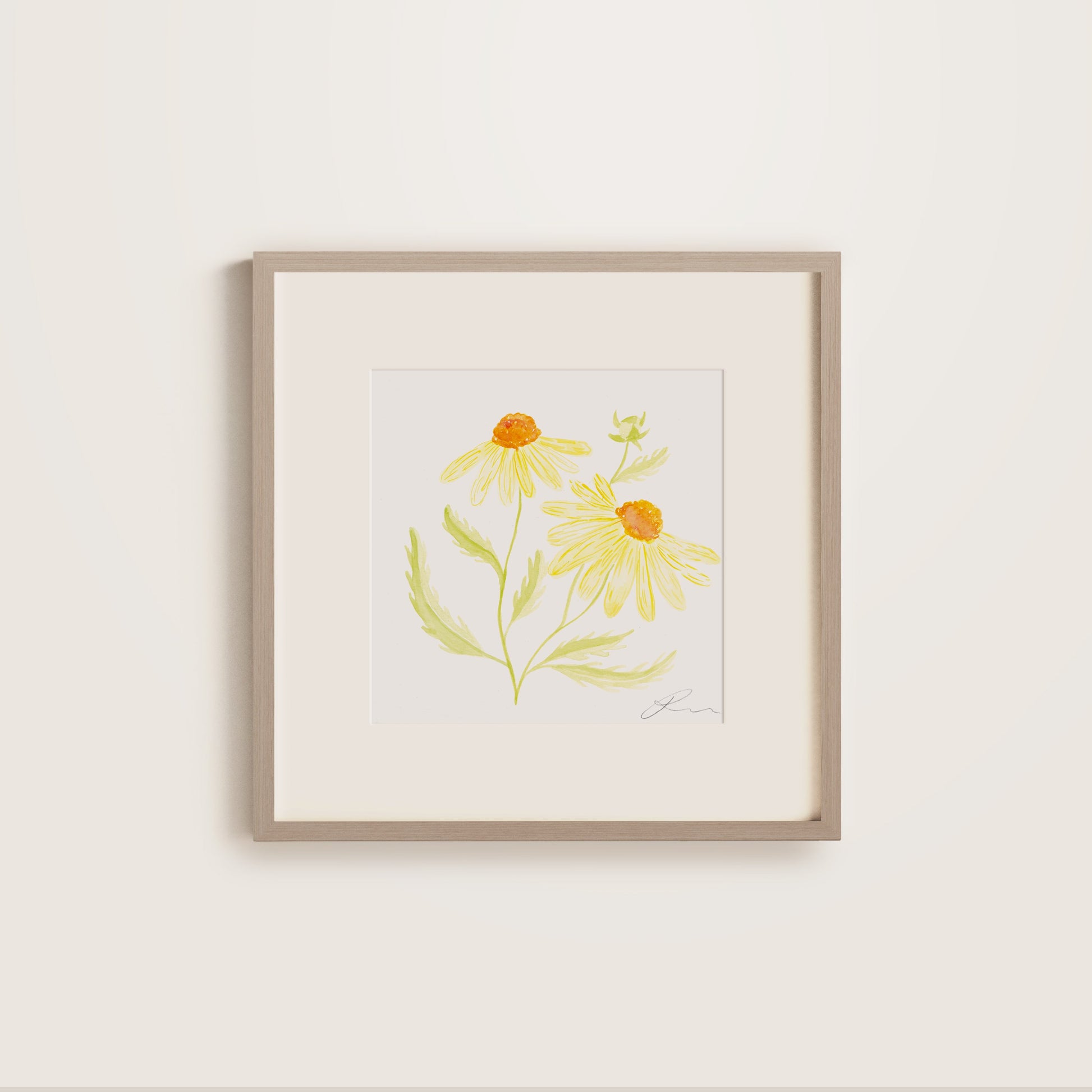 Wooden framed artwork of yellow daisy flowers on a white wall
