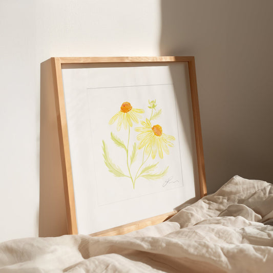 Framed artwork of a floral design on a bed with neutral background