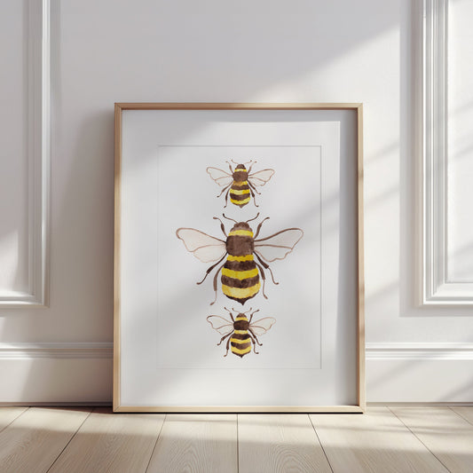Framed artwork of bees on a white wall
