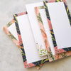pink, blue, green and orange dl notepads with lines and blank pages