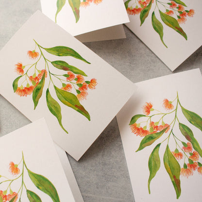 Greeting cards with floral designs on a grey surface