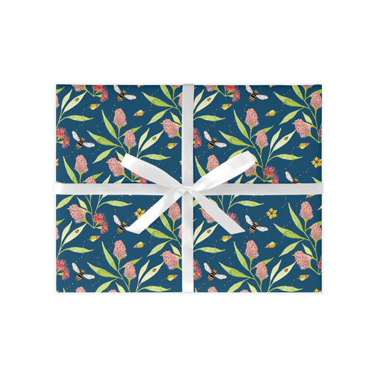 Gift box with floral pattern and white ribbon on a white background