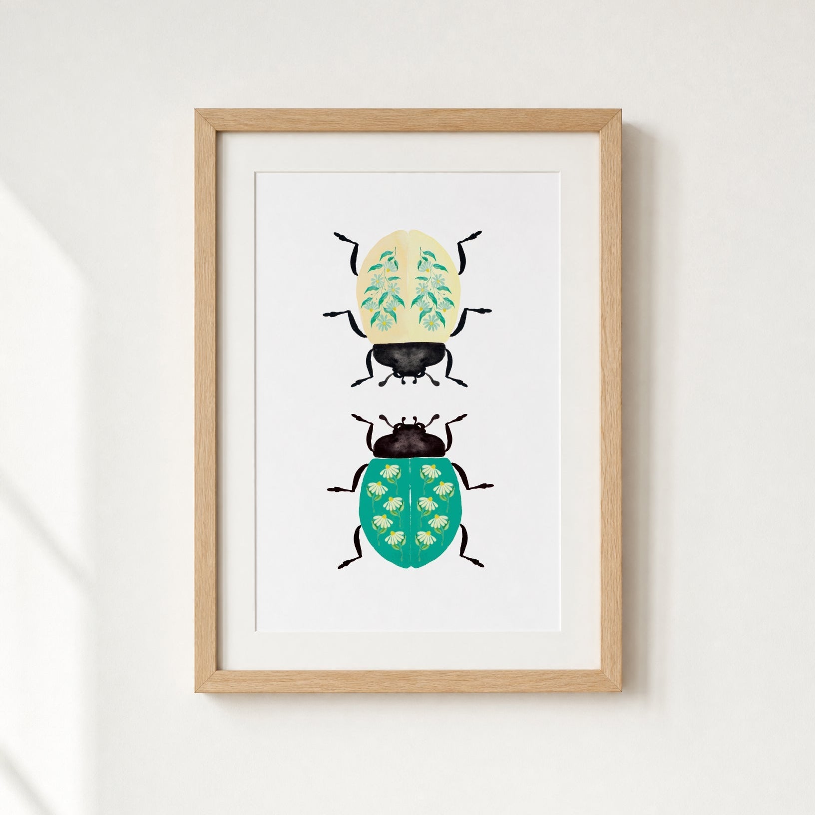 Framed artwork of two illustrated beetles on a white background