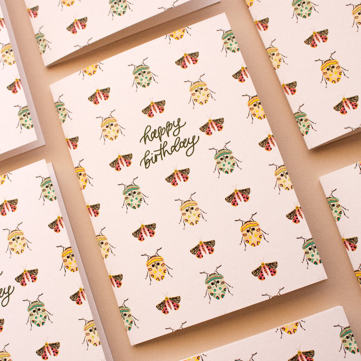 Australian made birthday card with beetle and moth pattern on natural background