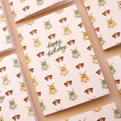 Australian made birthday card with beetle and moth pattern on natural background