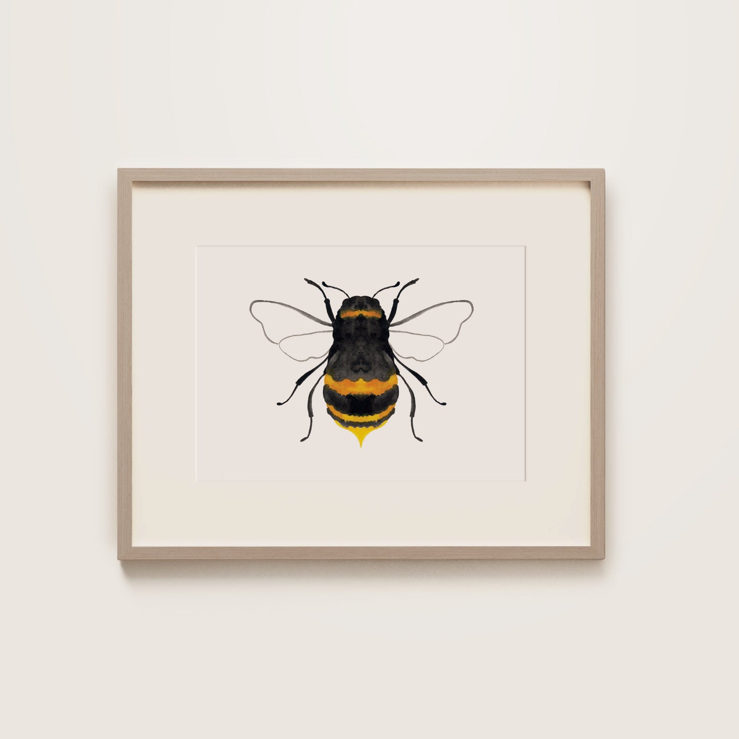 A watercolour print of a black bumble bee with yellow accents, wooden frame.