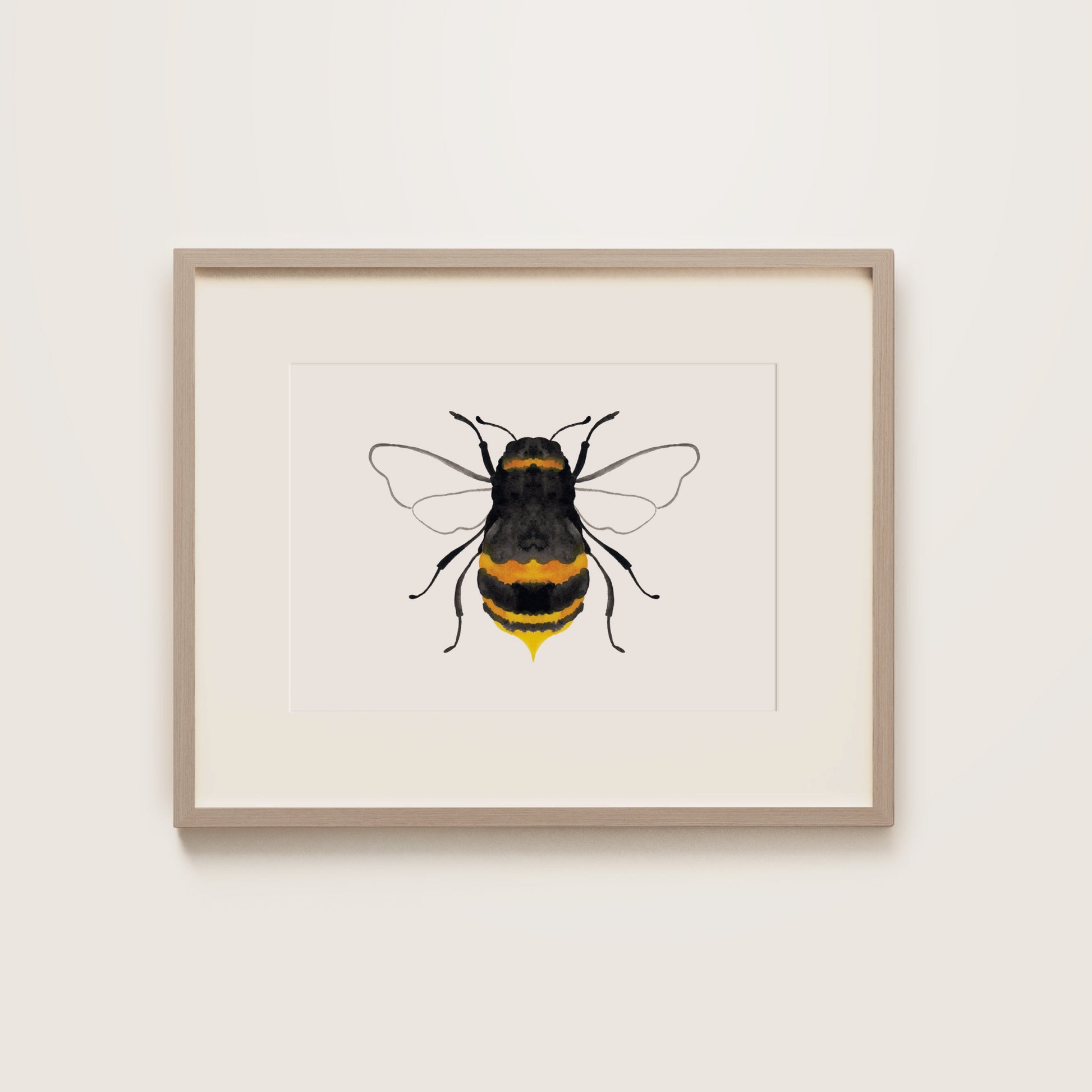 A watercolour print of a black bumble bee with yellow accents, wooden frame.