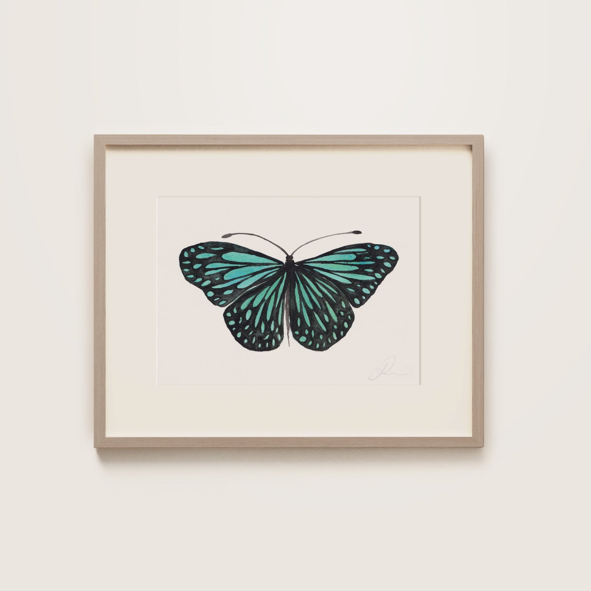 Framed artwork of a turquoise butterfly on a white background