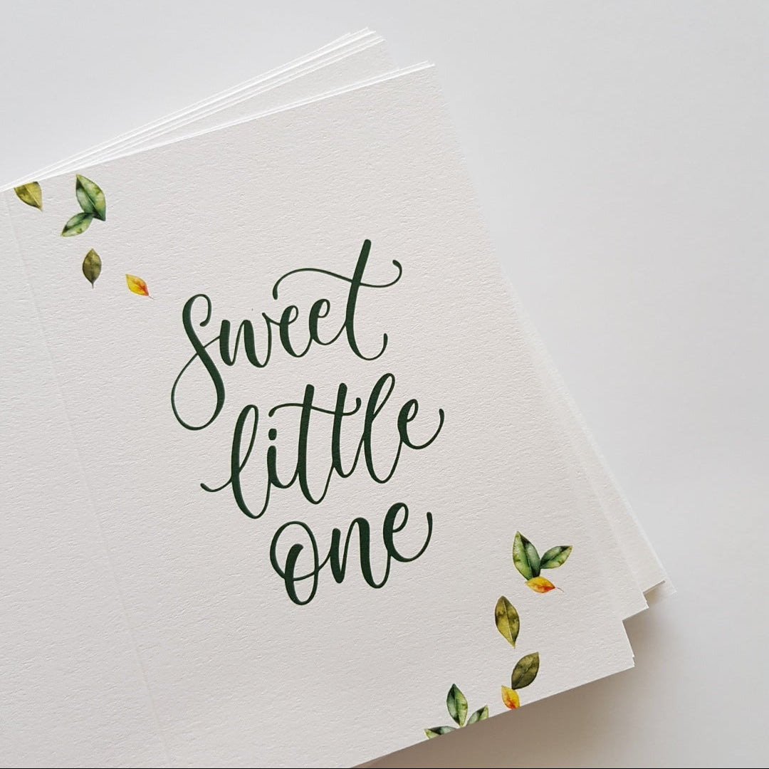 Stack of botanical greeting cards with the text 'Sweet little one'