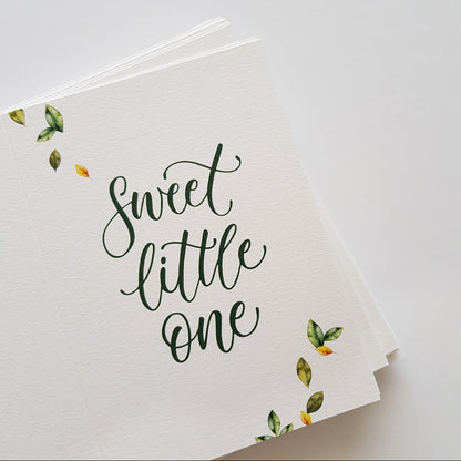 Stack of botanical greeting cards with the text 'Sweet little one'