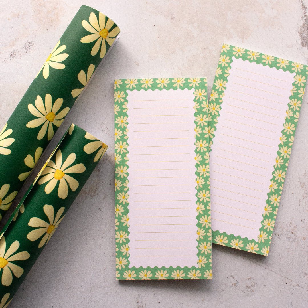 Teal DL notepads featuring daisies and lines, perfect for writing, with coordinating wrapping paper.