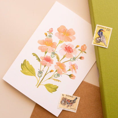 Botanical greeting card with soft pink flowers and teal beetle motif