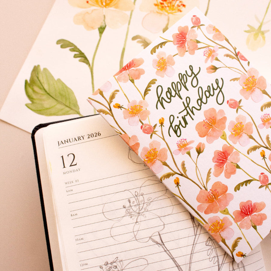 Floral notebook cover with 'Happy Birthday' text on a calendar page.