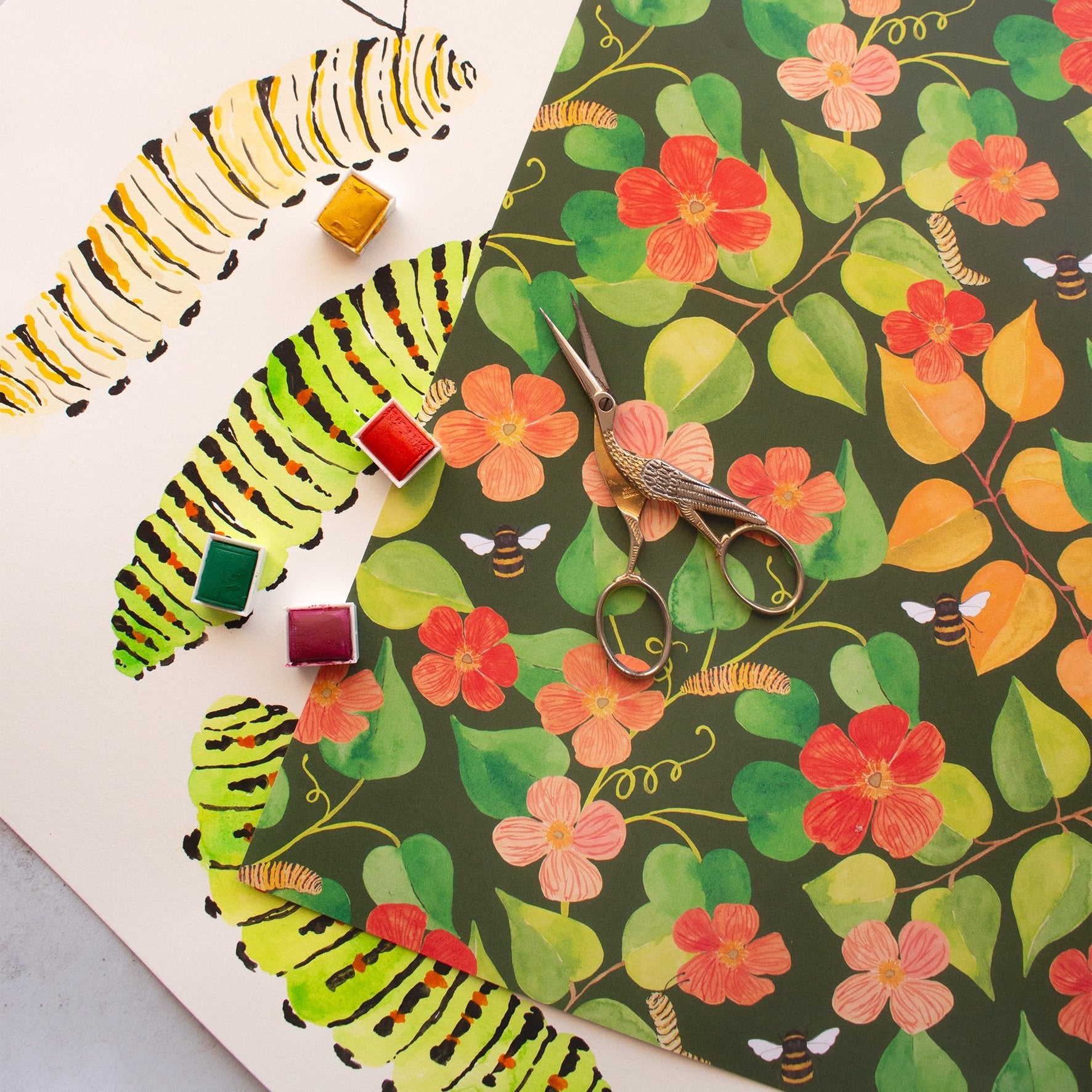 repeat leaf and poppy flower pattern flat sheet on-top of hand painted yellow and green caterpillars