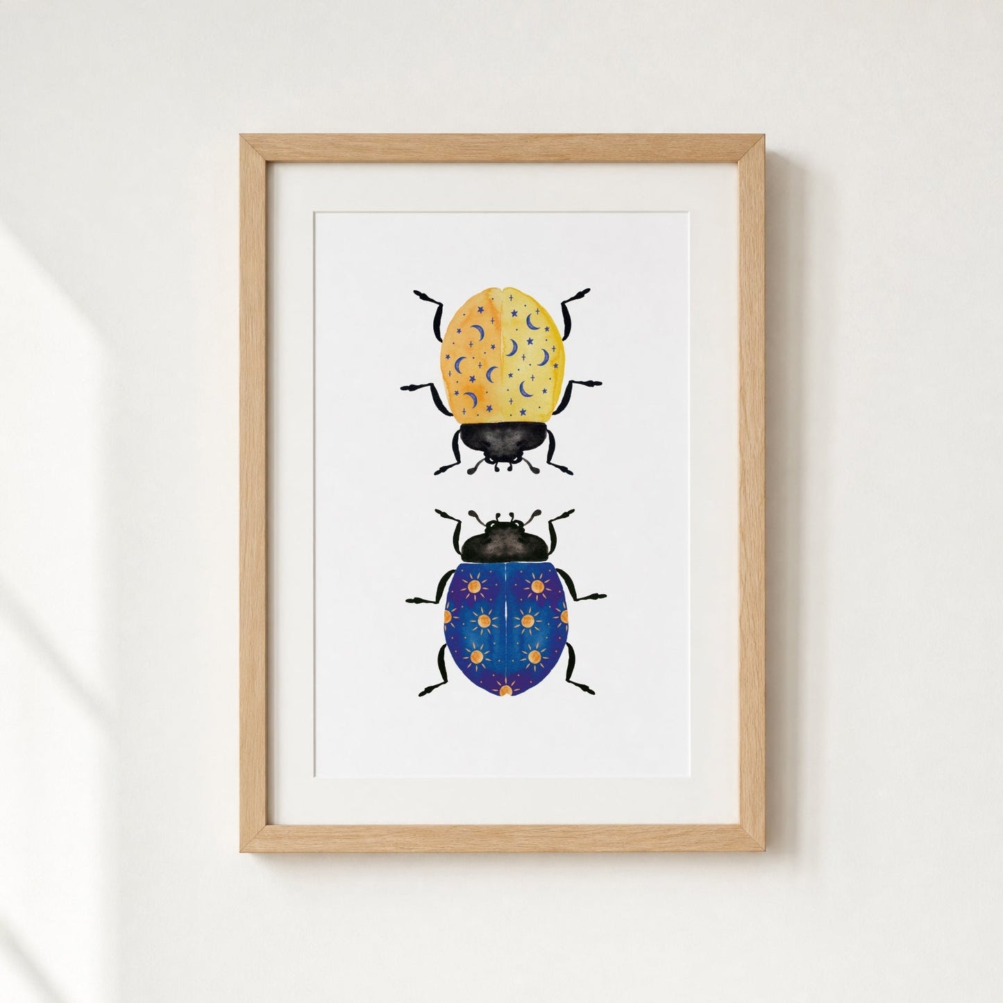 Framed artwork of two illustrated beetles on a white background