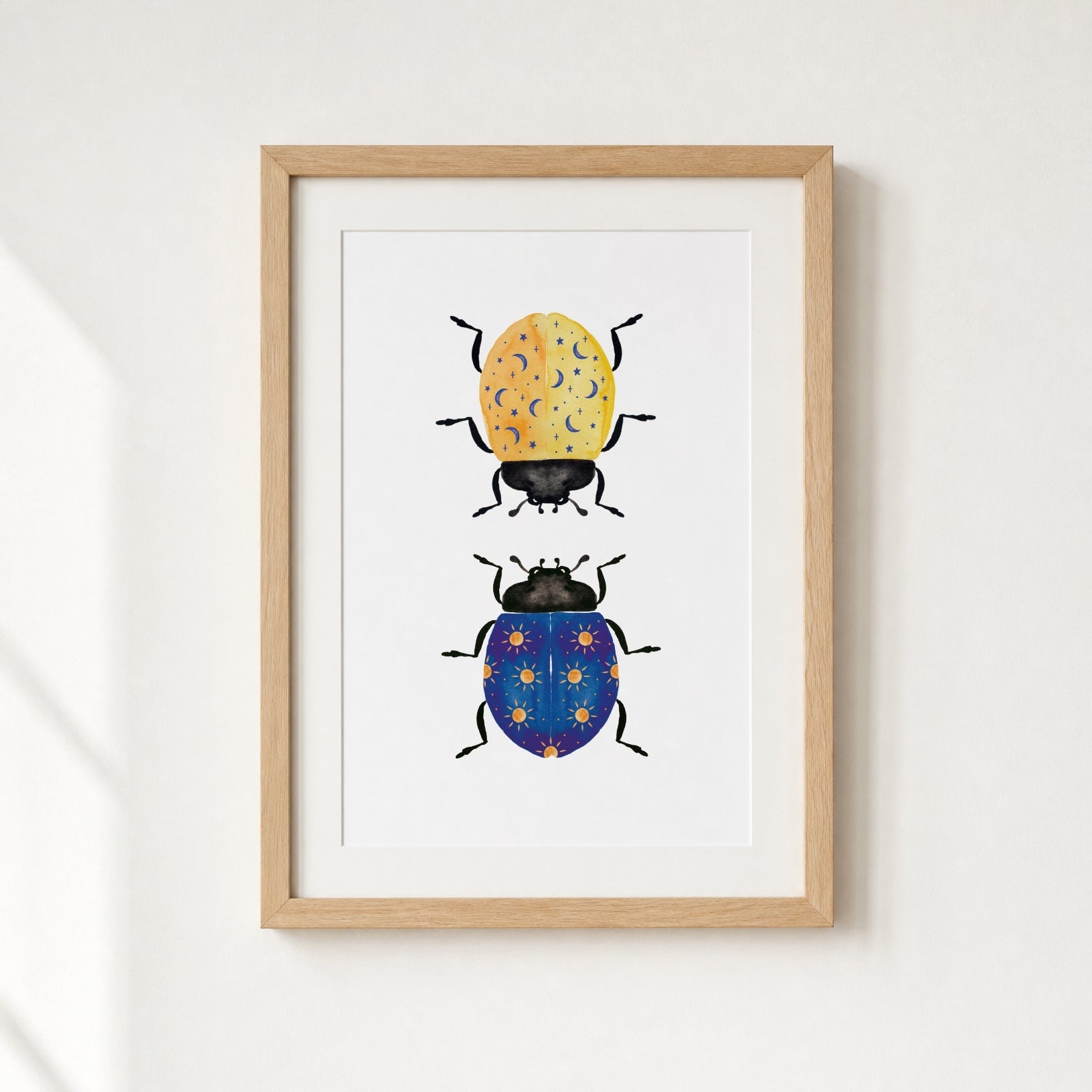 Framed artwork of two illustrated beetles on a white background