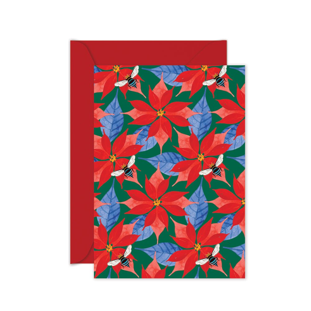A Christmas card with a repeated pattern of red poinsettias and blue leaves on a green background, featuring a native blue banded bee. 