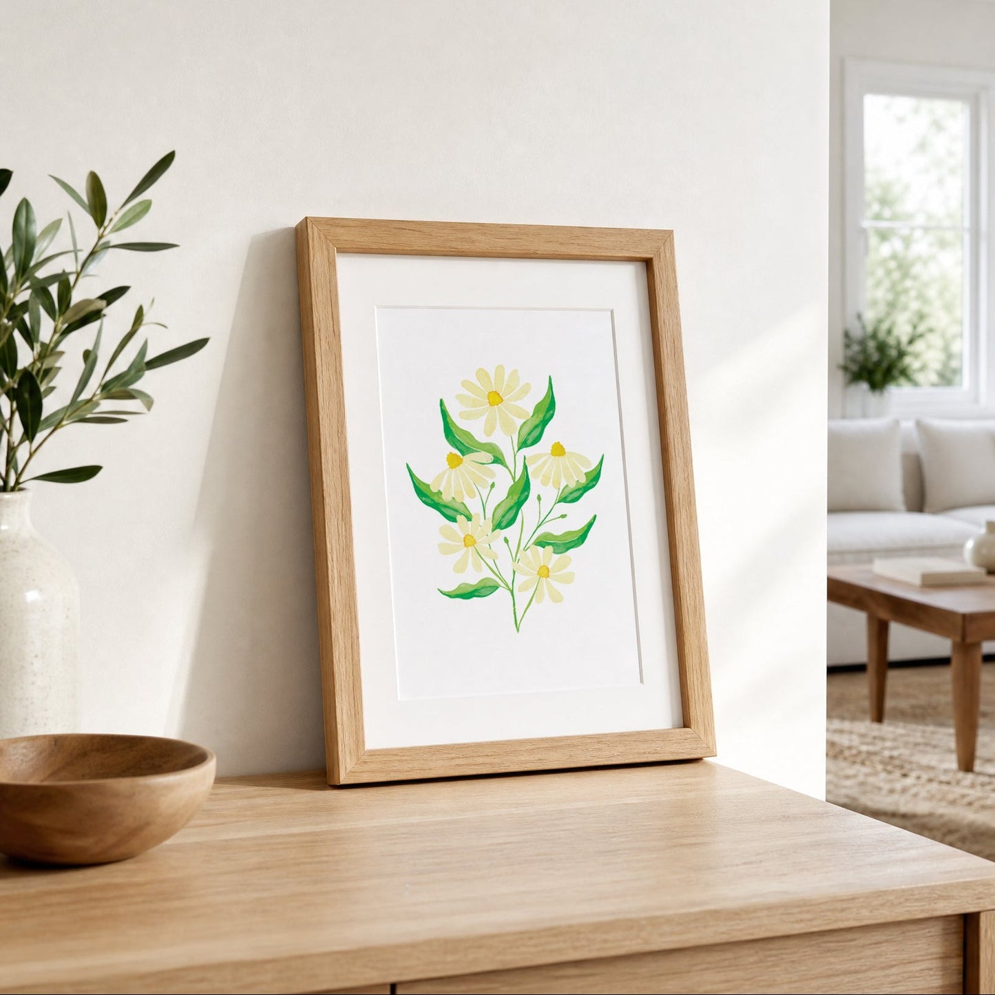 Framed artwork of a floral design on a wooden surface in a bright room.