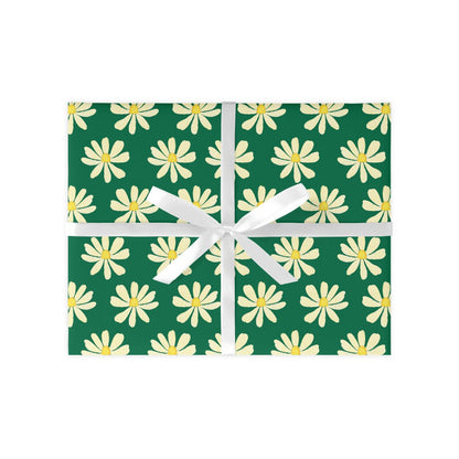 A sheet of wrapping paper with a green background and white daisy patterns, tied with a white ribbon.