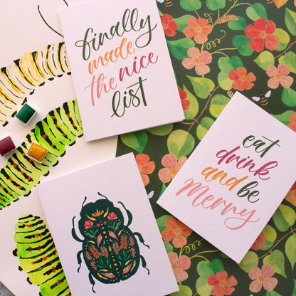 Greeting cards with caterpillar illustrations and text on a floral background