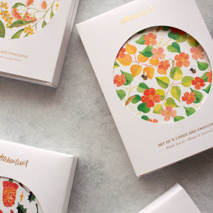 Four boxes with greeting cards on a grey surface
