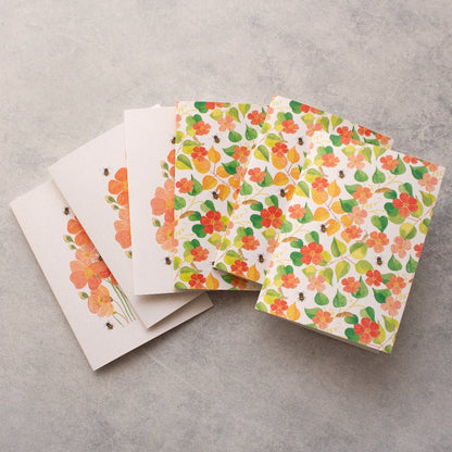 Floral patterned cards on a grey surface