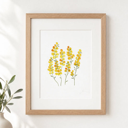 Framed artwork of yellow flowers on a white wall
