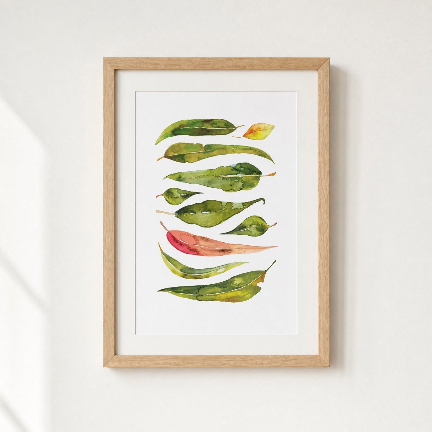 Framed artwork of colorful leaves on a white background