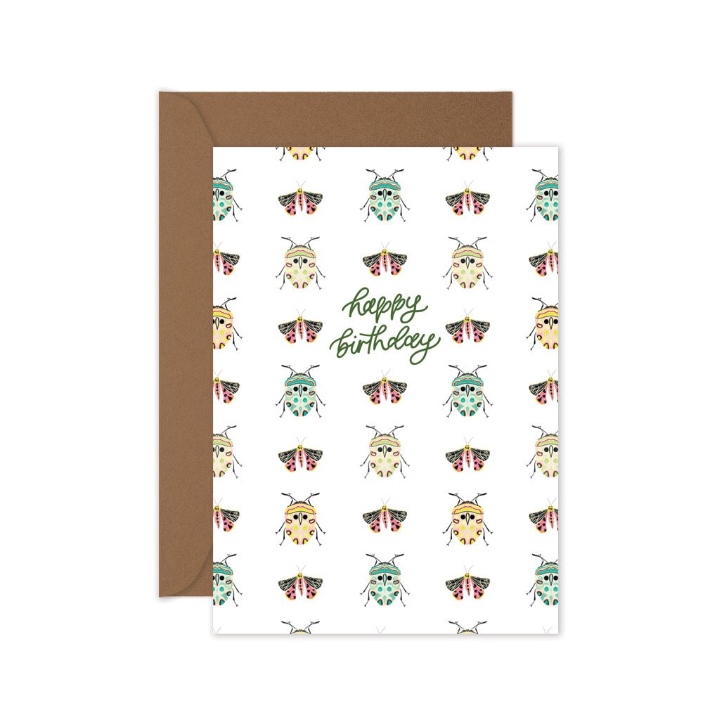 Greeting card with beetle pattern and 'Happy Birthday' text, brown envelope.