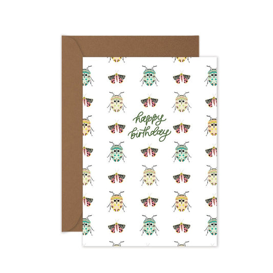 Greeting card with beetle pattern and 'Happy Birthday' text, brown envelope.