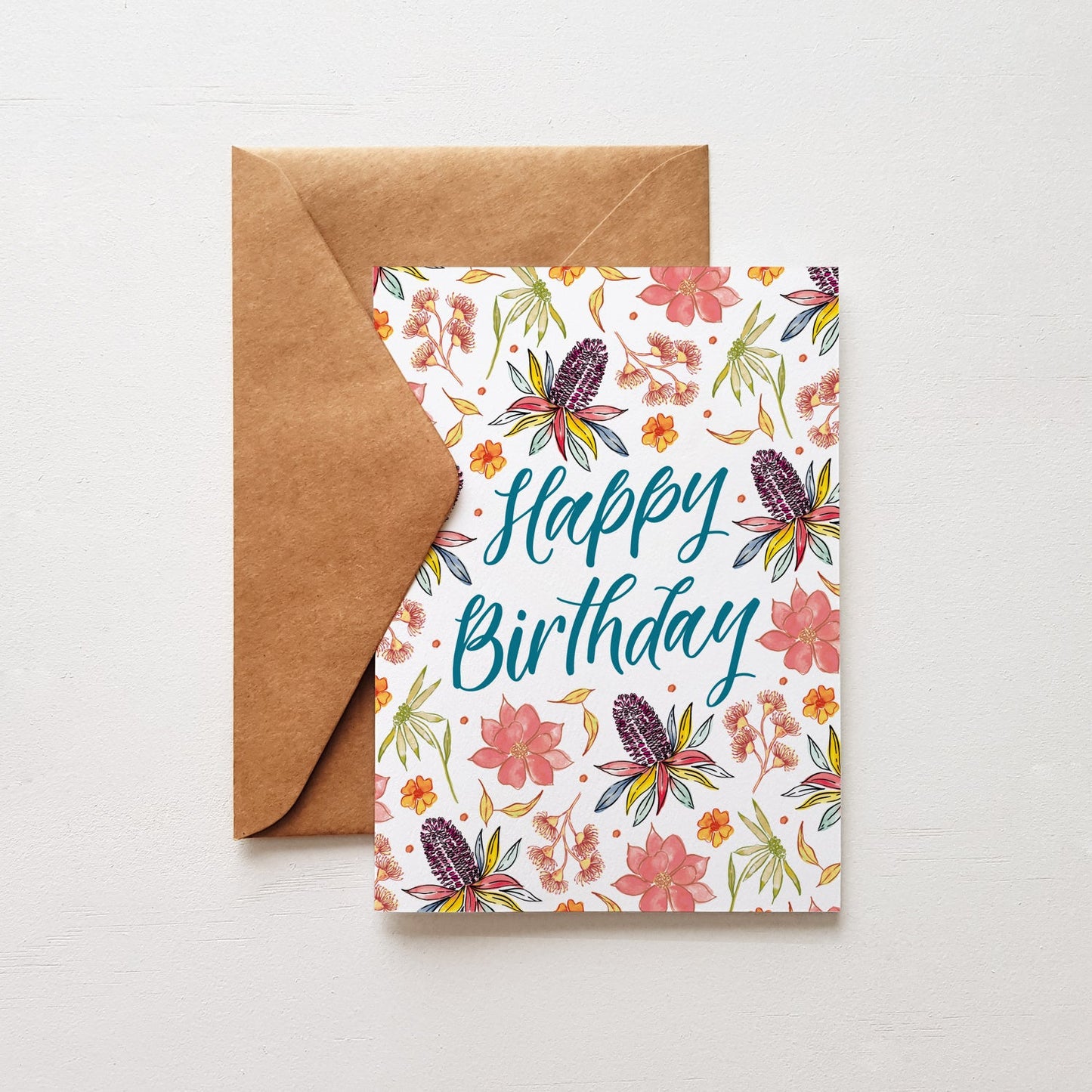 Floral birthday card with 'Happy Birthday' text and brown envelope on white background