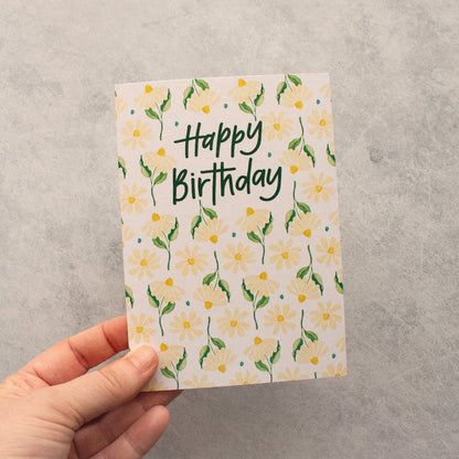 hand holding happy birthday repeat daisy pattern greeting card