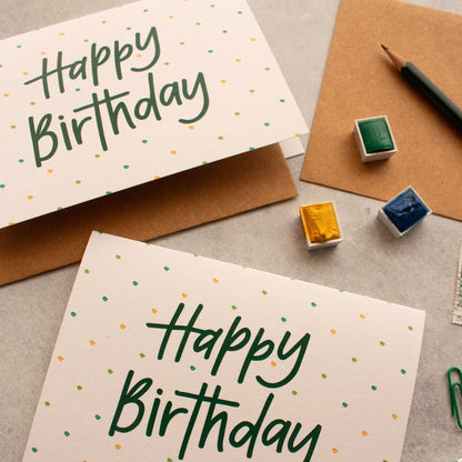 Bright Happy Birthday card featuring vibrant yellow, green, and blue dots for a cheerful celebration.