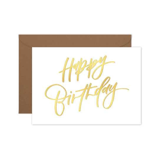 Happy birthday greeting card with gold foil hand lettering on a brown envelope